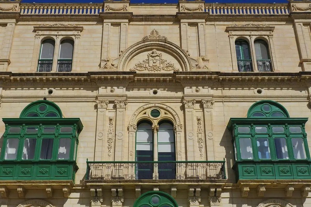 Limestone facade with traditional green Maltese balconies