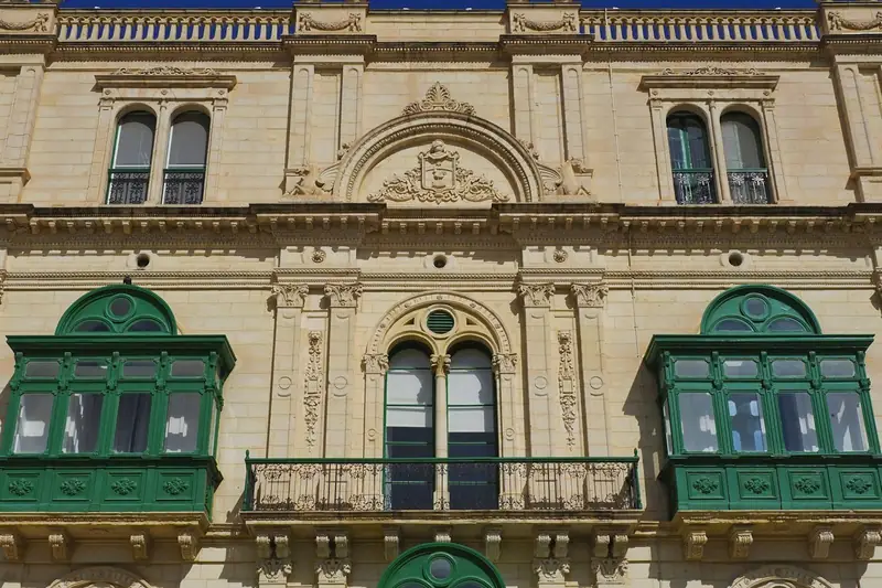 Limestone facade with traditional green Maltese balconies